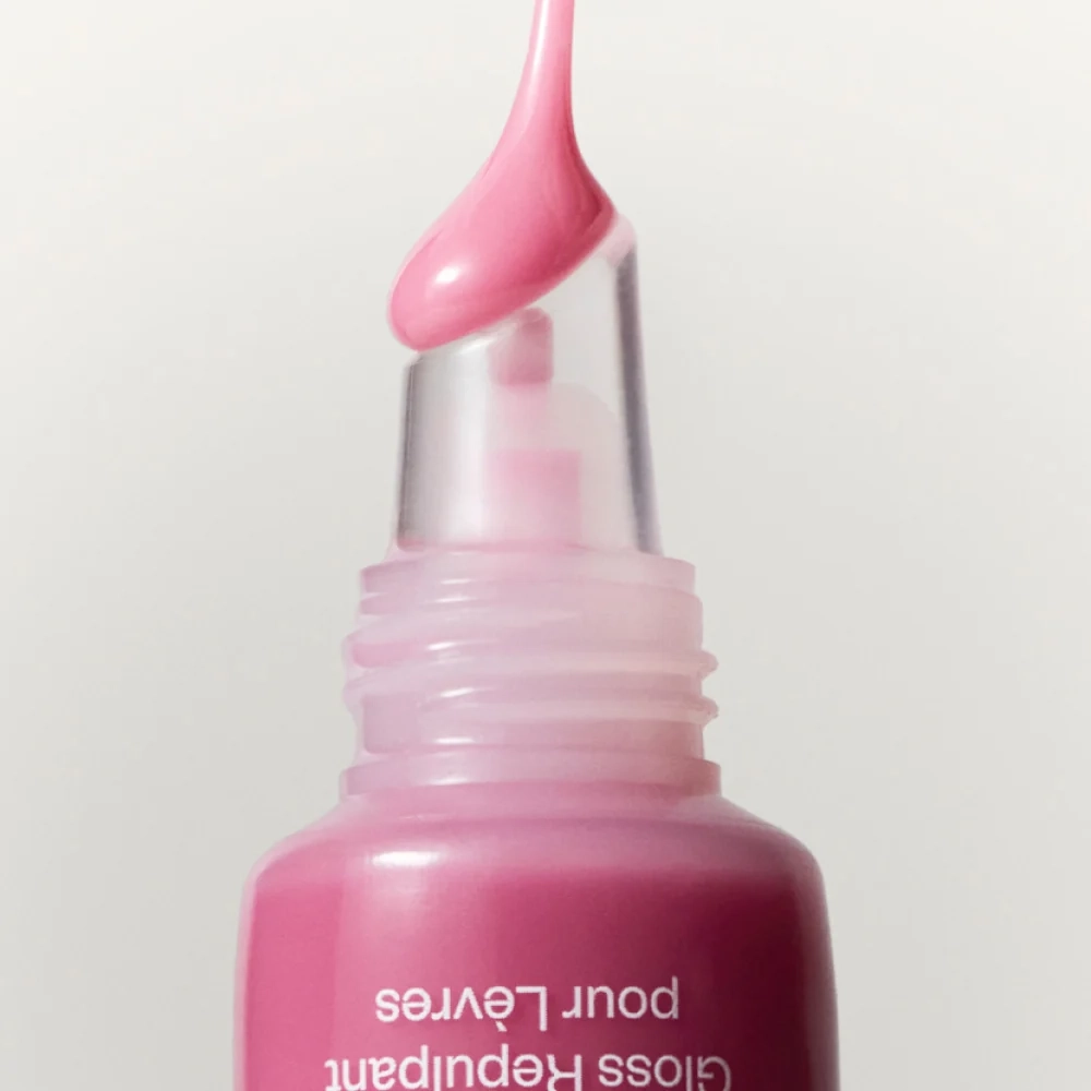Lip: a pink gloss tube with a drop of gloss